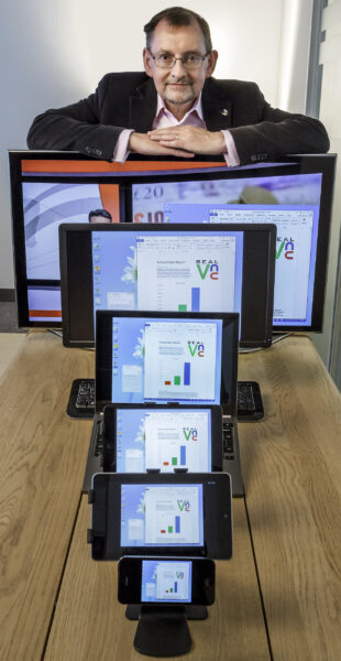 Dr Andy Harter leaning on a computer monitor