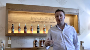 Dougal Sharp standing in front of an Innis & Gunn bar.