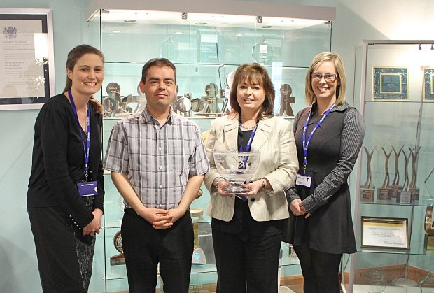 The Allstate NI team holding their 2005 Queen's Award.