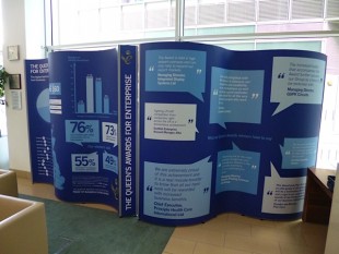 Queen's Awards window display showing data on the awards.