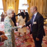 Richard Naylor shaking hands with the Queen.