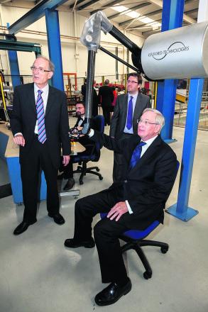 The Duke of Gloucester tests a robotic arm.