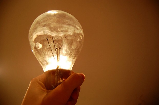 Hand holding a lightbulb.