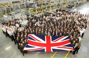 Workers at Jaguar Land Rover holding a Union Jack.